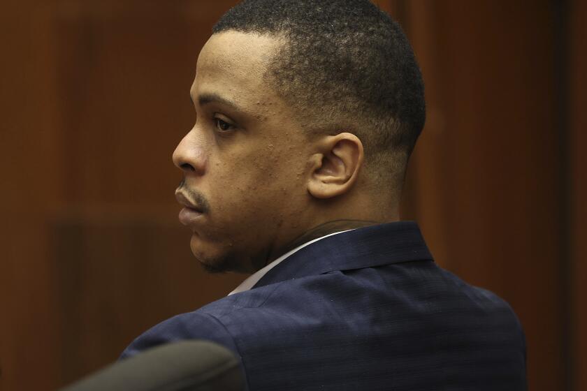 Defendant Eric Holder listens during opening statements in his murder trial, Wednesday, June 15, 2022, at Los Angeles Superior Court in Los Angeles. Holder, 32, faces one count of first degree-murder and two counts of attempted first-degree murder for the killing the Grammy Award-winning rapper Nipsey Hussle outside his clothing store three years ago. (Frederick M. Brown/Daily Mail.com via AP, Pool)