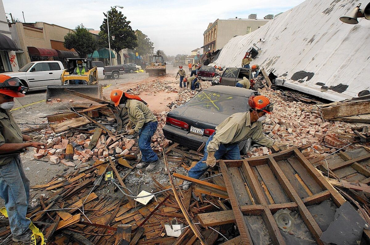 Rescue workers sift through debris in the wake of the 2003 Paso Robles earthquake. The families of the two women killed by falling bricks and plaster in an old building sued the property owners. A jury awarded the families nearly $2 million.