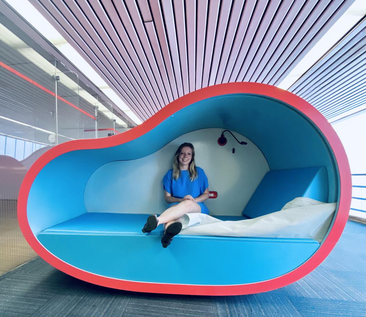 Marta Nowak sits inside a sleeping pod.