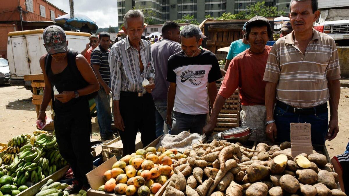 People buy groceries at the municipal market of Coche, a neighborhood of Caracas on Aug. 18.