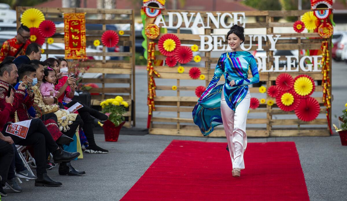 A model walks the runway during a fashion show featuring "Ao Dai."