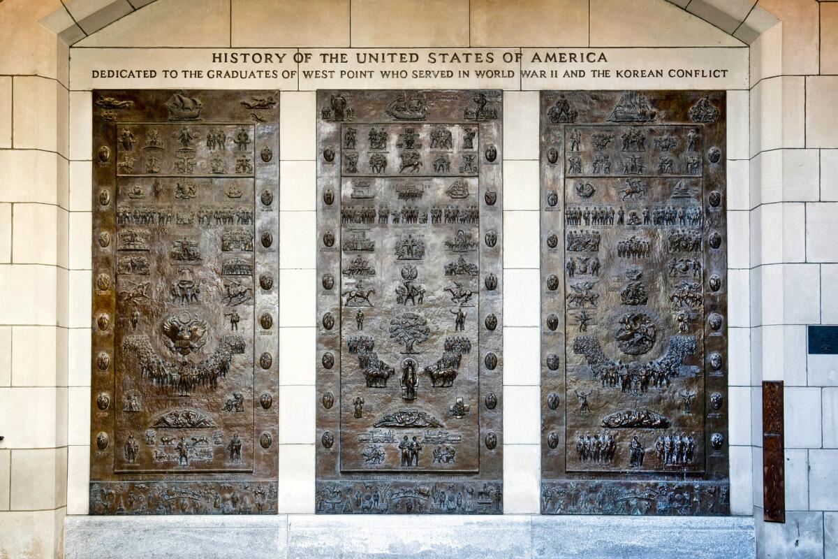 This photo provided by the U.S. Military Academy at West Point, in New York, shows the three bronze panels at one of the entrances to Bartlett Hall, at West Point, that depicts the history of the United States. A commission created by Congress is recommending that multiple historical reminders tied to Confederate officers during the Civil War be removed — many honoring Robert E. Lee, one of the academy's most famous graduates. (U.S. Military Academy at West Point via AP)
