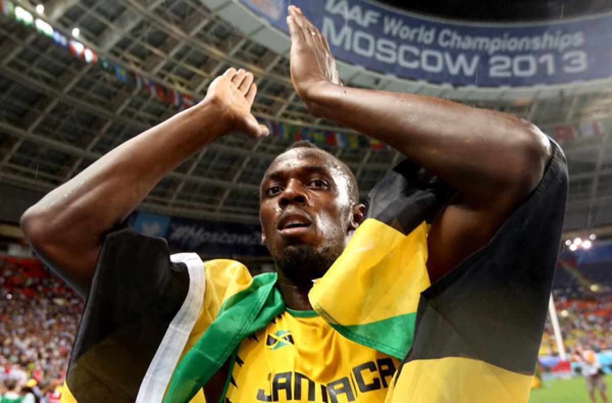 Usain Bolt applauds the crowd after winning the 100-meter dash at the world championships on Sunday in Moscow.