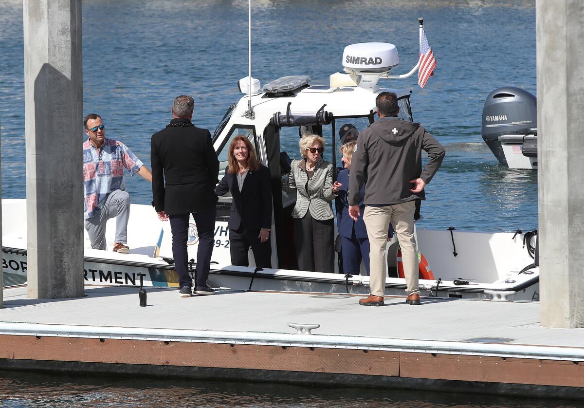 Local officials pull up to the new Balboa Marina Public Pier on a harbor department boat after Friday's ceremony.