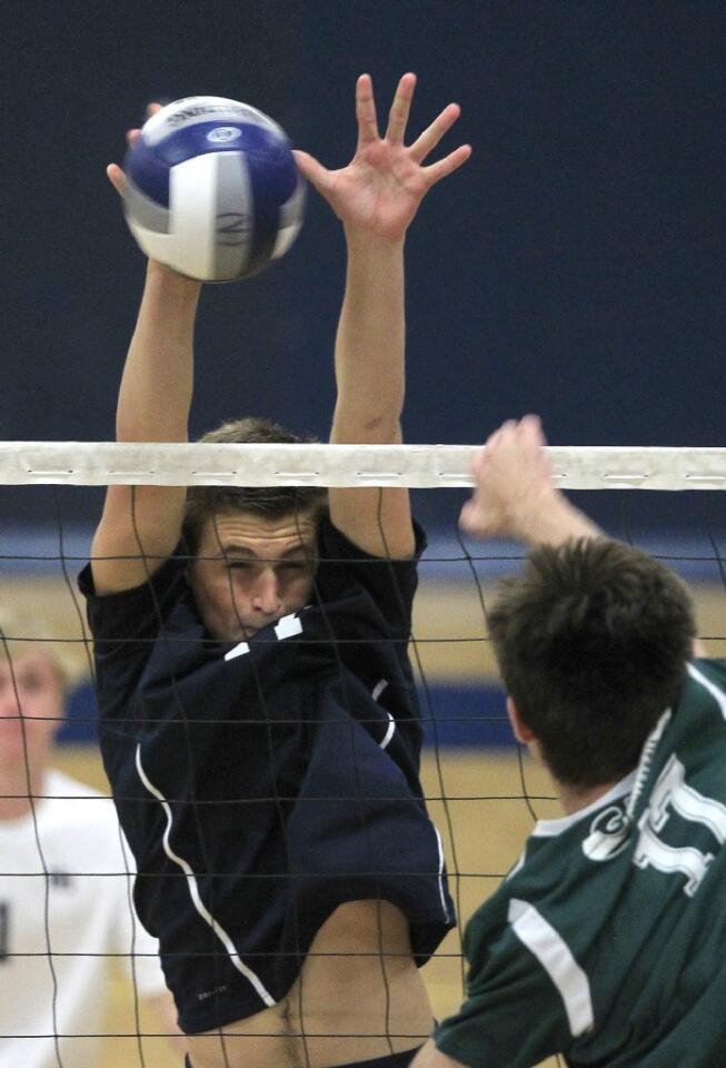 Newport Harbor High's Collin Schlesinger, left, blocks a shot by Edison's Shad Harris during a Sunset League match on Tuesday.