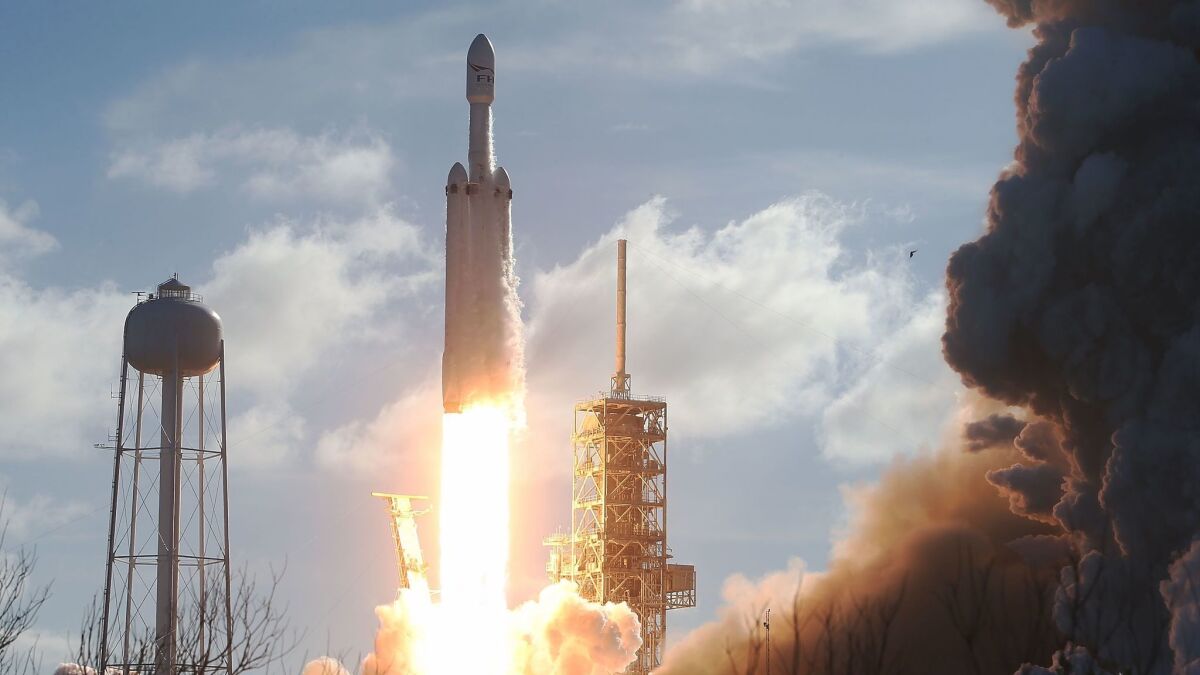 SpaceX's Falcon Heavy rocket lifts off from Launch Complex 39A at Kennedy Space Center in Florida on February 6, 2018. The rocket is the most powerful rocket in the world and is carrying a Tesla Roadster into orbit.