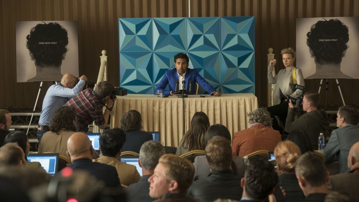 Jack Malik (Himesh Patel, center) faces the press for the launch of his debut album, flanked by his agent Debra (Kate McKinnon, right) in "Yesterday."