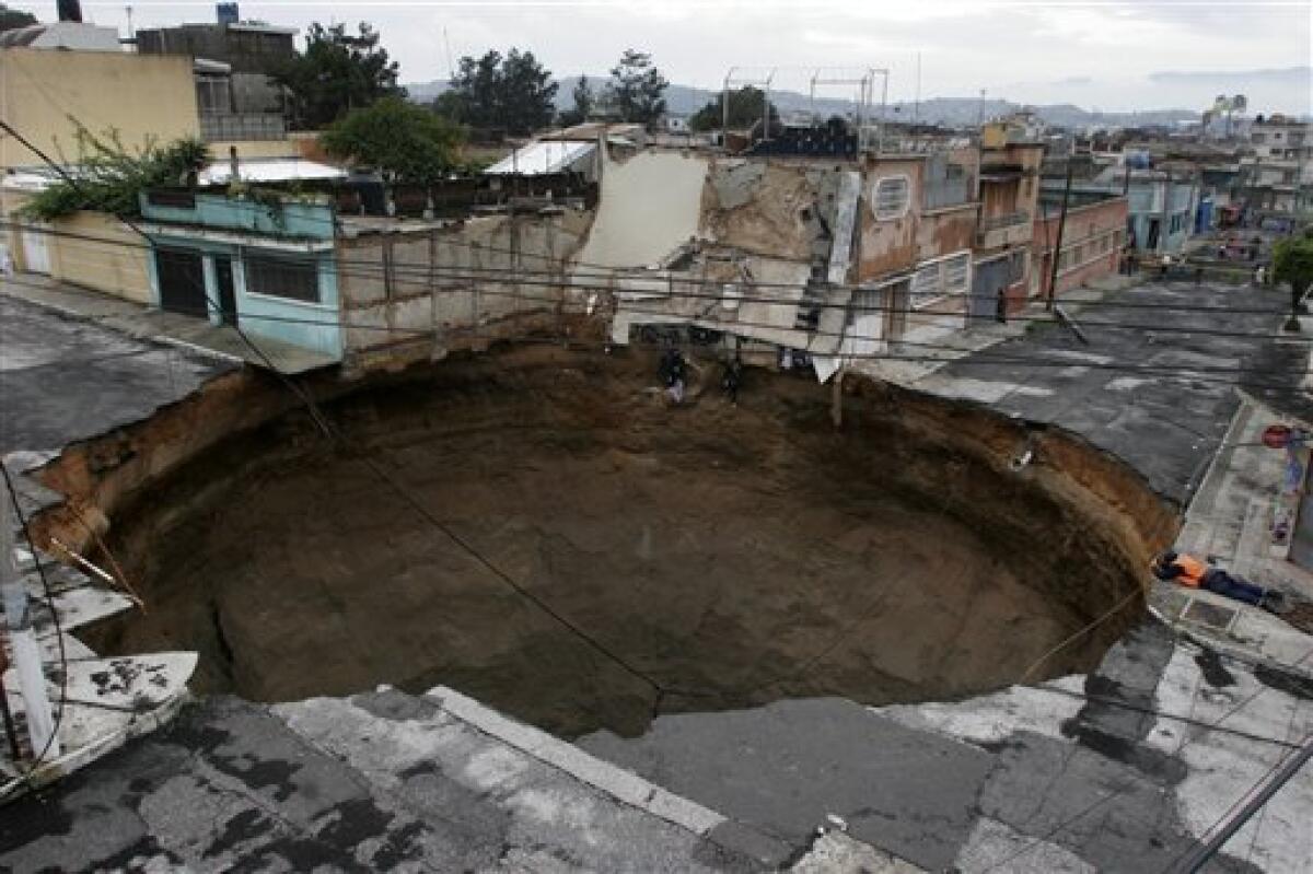 A sinkhole created by tropical storm Agatha covers a street intersection in dowtown of Guatemala City on Sunday, May 30, 2010. Torrential rains brought by the first tropical storm of the 2010 season pounded Central America and southern Mexico, triggering deadly landslides.(AP Photo/STR)