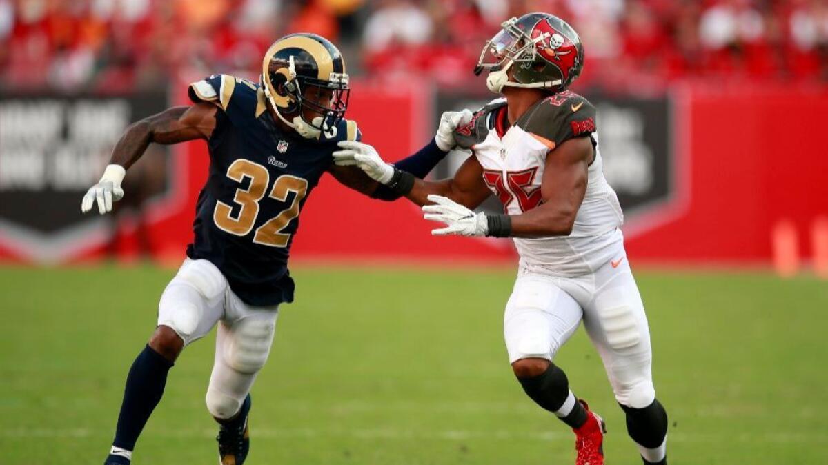 Rams cornerback Troy Hill battles with Buccaneers running back Mike James during a game on Sept. 25.