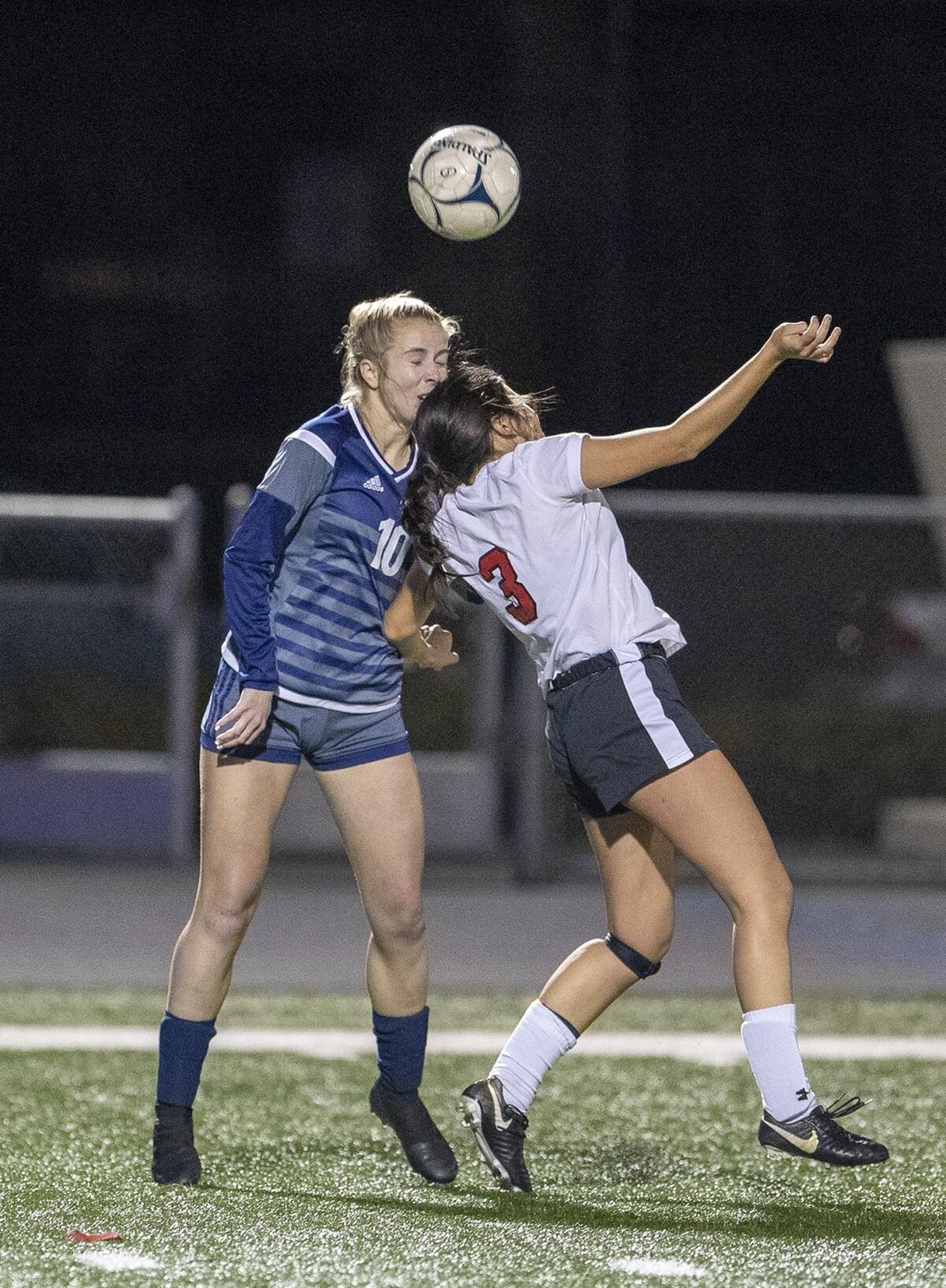 Newport Harbor High's Mackenzee Blaser, left, goes up for a header against Mission Viejo's Madilyn Fawcett in the first round of the CIF Southern Section Division 1 playoffs on Wednesday.