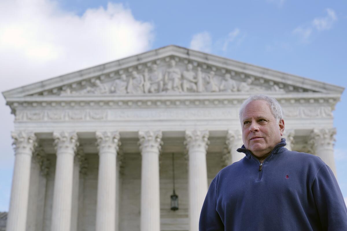 A man poses for a photo outside the U.S. Supreme Court