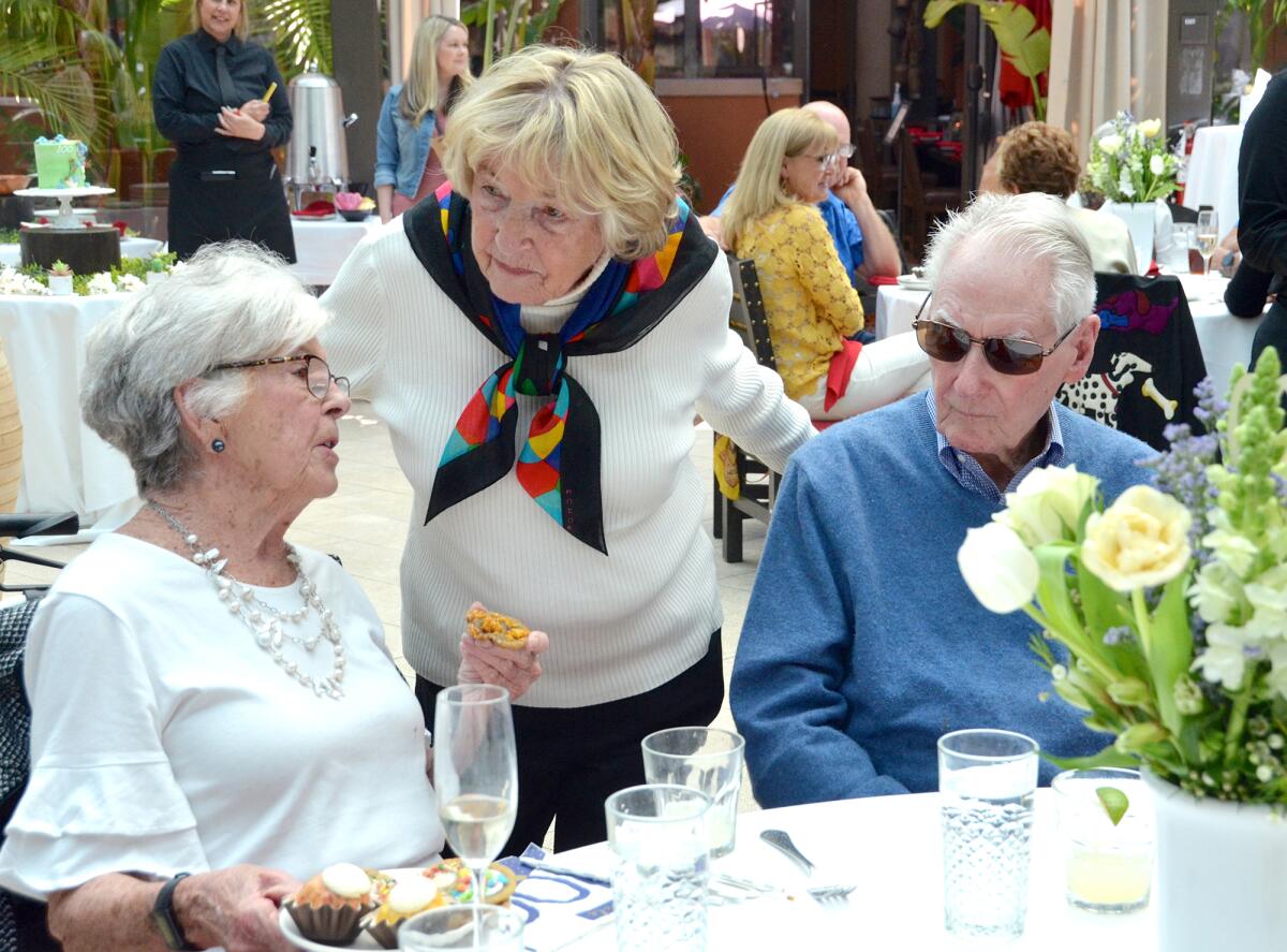 Birthday girl Pat Maurer table hops during her 100th birthday party Saturday at Newport Beach's Red O restaurant.