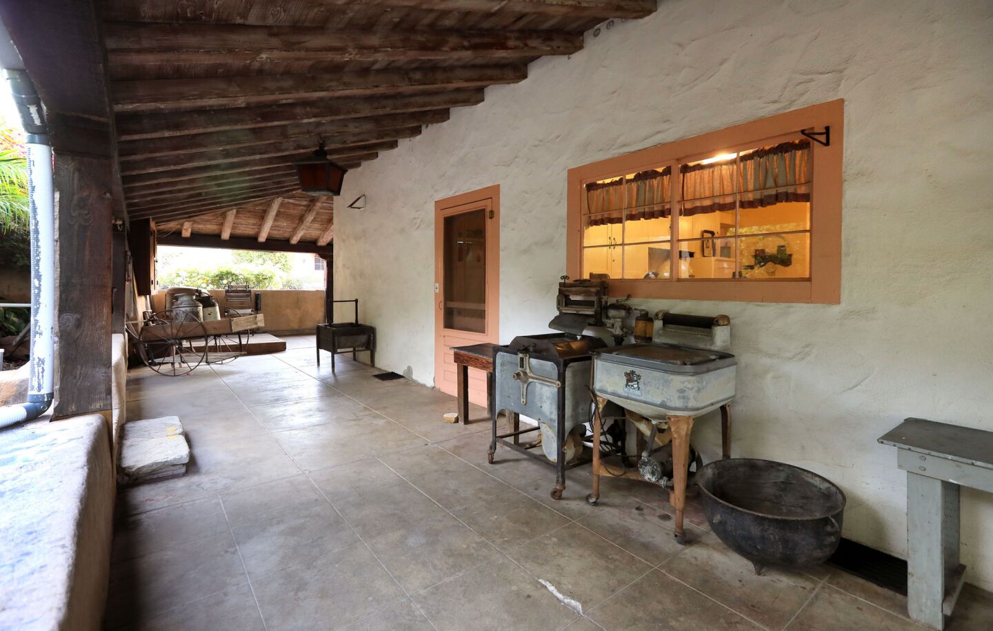 View of a covered patio near the kitchen at the Rancho Buena Vista Adobe. A walled-off root cellar was situated underneath this walkway in the 1800s. Spirits on the property have said that men were kept captive in the root cellar.