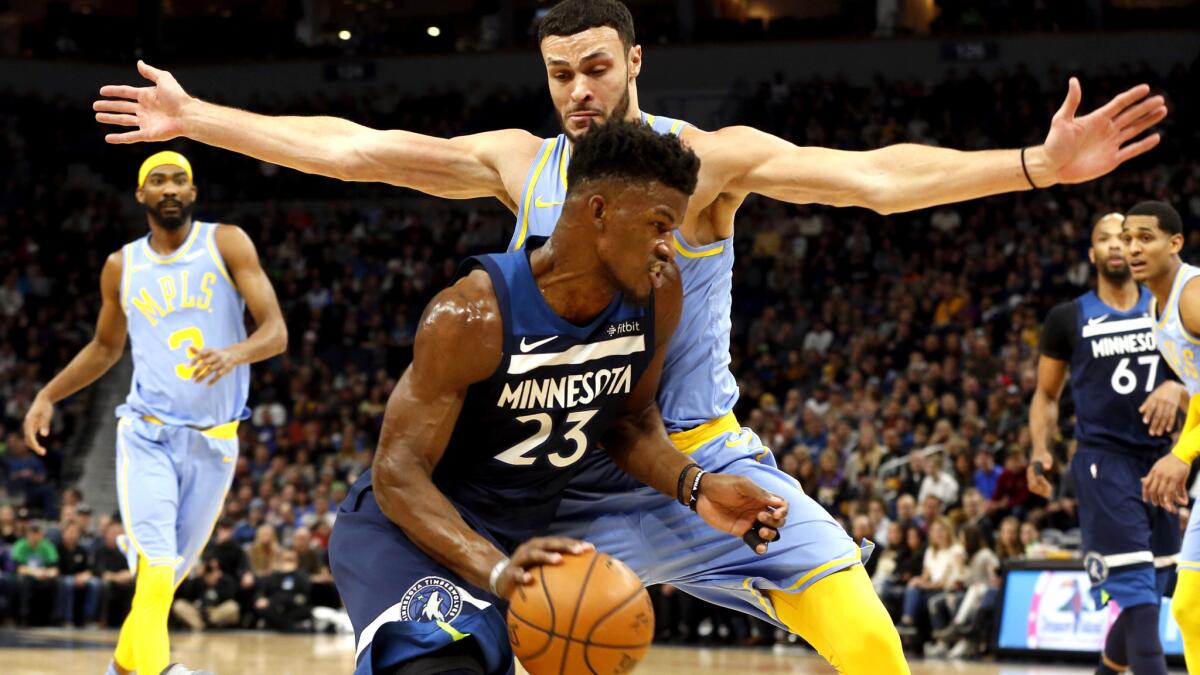 Lakers forward Larry Nance Jr. tries to cut off a drive by Timberwolves guard Jimmy Butler during their Jan. 1 game in Minneapolis.