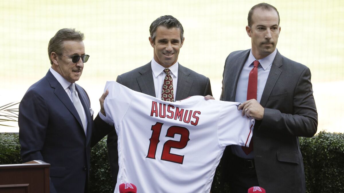 Brad Ausmus, flanked by Angels owner Arte Moreno, left, and general manager Billy Eppler, is the new manager of the club.