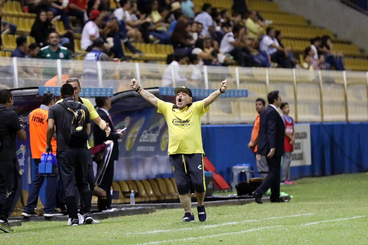 Maradona celebrates, with no help from a cane, after a goal.