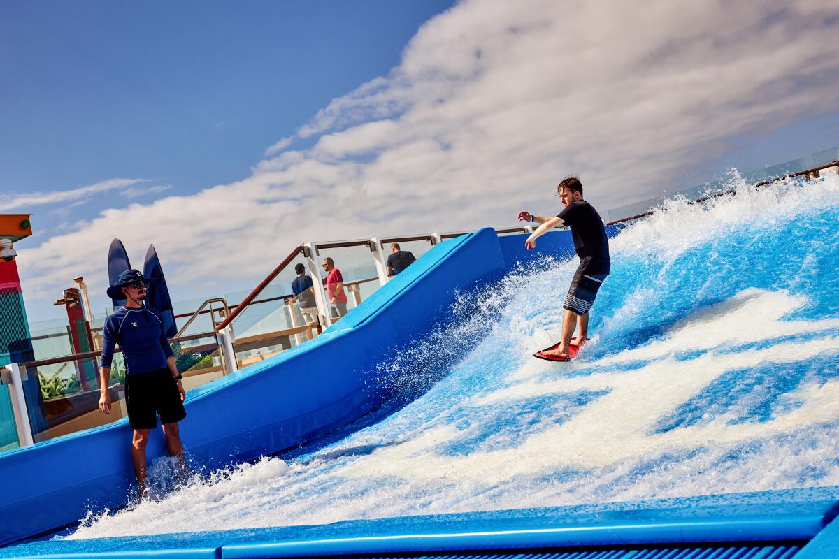 A guest takes a spin on the 40-foot-long FlowRider surf simulator.