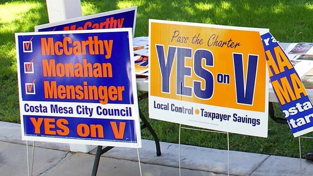 Costa Mesa voters will be asked in November whether the city should switch from at-large to district-based elections. These campaign signs are from a past election.