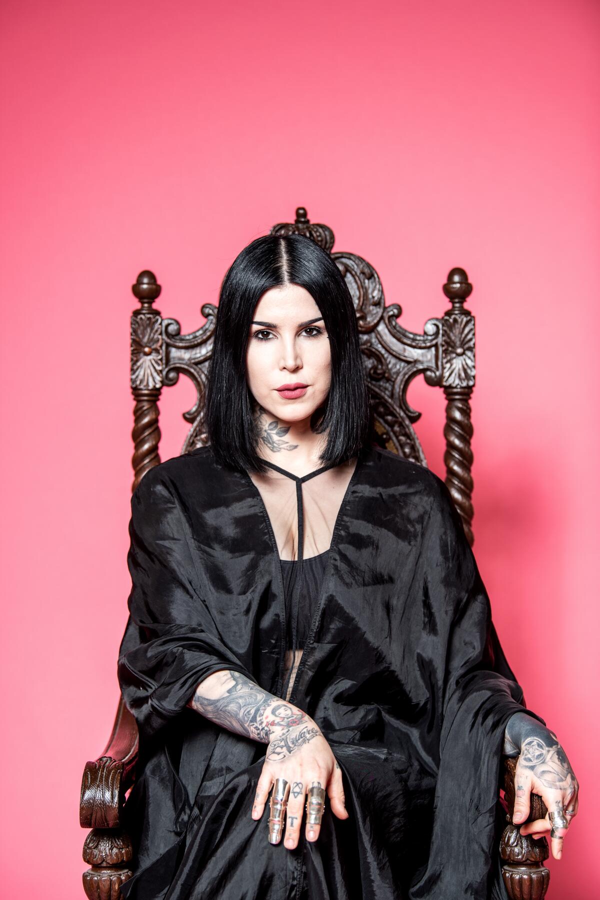 Kat Von D in a throne-like chair.