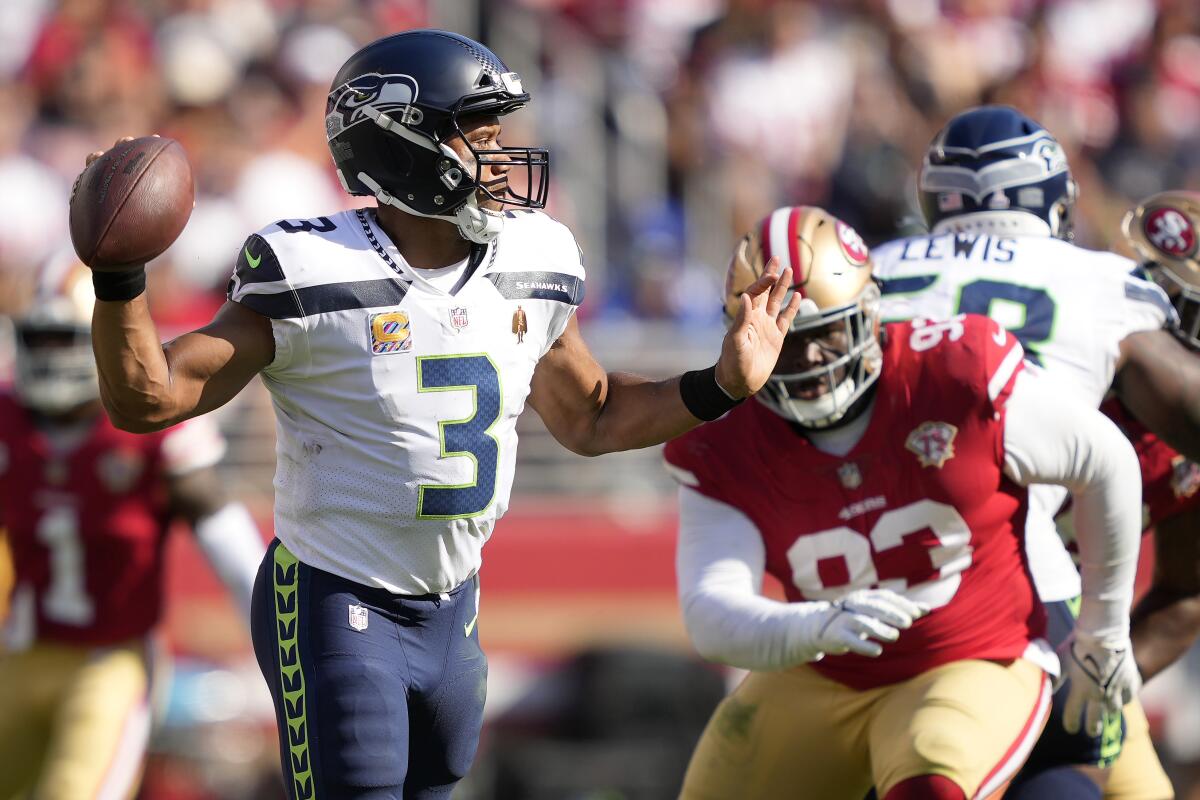 Seattle Seahawks quarterback Russell Wilson (3) passes in front of San Francisco 49ers defensive tackle D.J. Jones during the second half of an NFL football game in Santa Clara, Calif., Sunday, Oct. 3, 2021. (AP Photo/Tony Avelar)