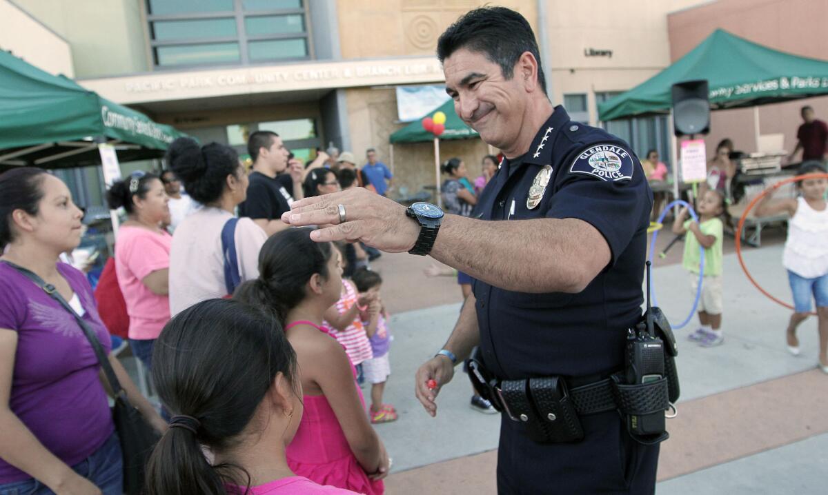 Glendale Police chief Robert Castro makes his way through the crowd at Pacific Park during a National Night Out event on Tuesday, August 5, 2014.