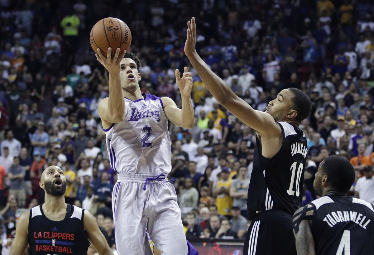 Los Angeles Lakers' Lonzo Ball shoots over Los Angeles Clippers' Brice Johnson during an NBA summer league basketball game on July 7, 2017 in Las Vegas.