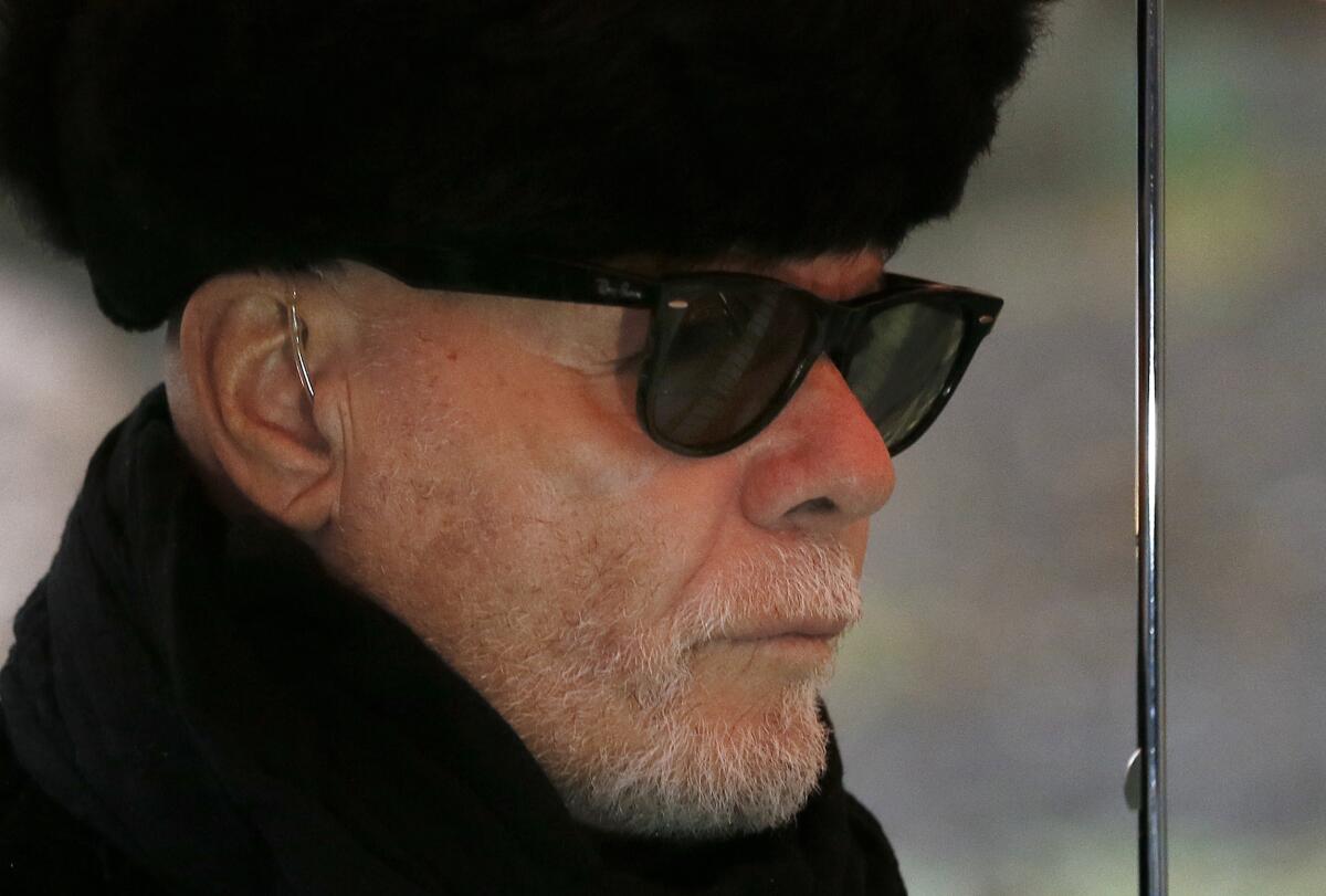 British pop star Gary Glitter in dark glasses and a black hat