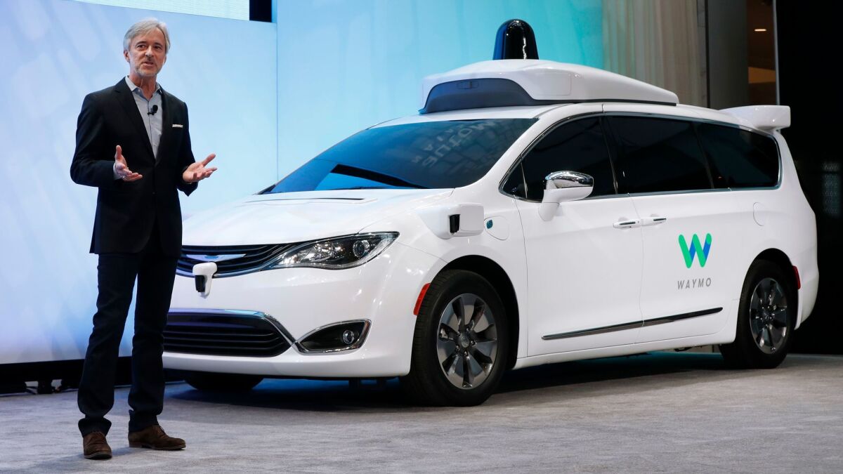 John Krafcik, CEO of Waymo, the autonomous-vehicle company created by Google, introduces a Chrysler Pacifica hybrid outfitted with Waymo's own suite of sensors and radar at the North American International Auto Show in Detroit in January.