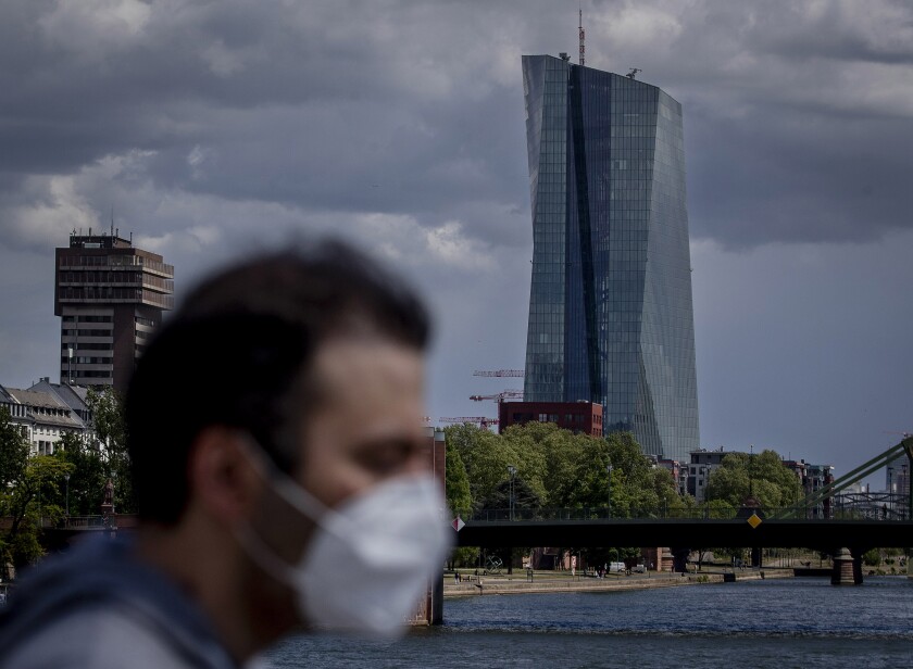 A man walks in front of the European Central Bank in Frankfurt, Germany