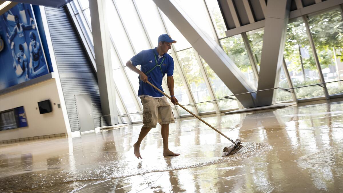 Water is pushed out of Pauley Pavilion on Tuesday afternoon after a broken water main under Sunset Boulevard caused flooding throughout UCLA's campus.