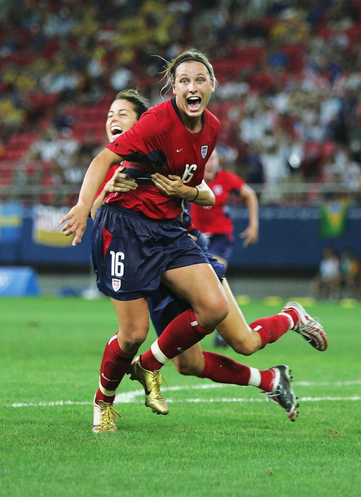 Abby Wambach, front, celebrates with Julie Foudy after scoring in extra time to beat Brazil.
