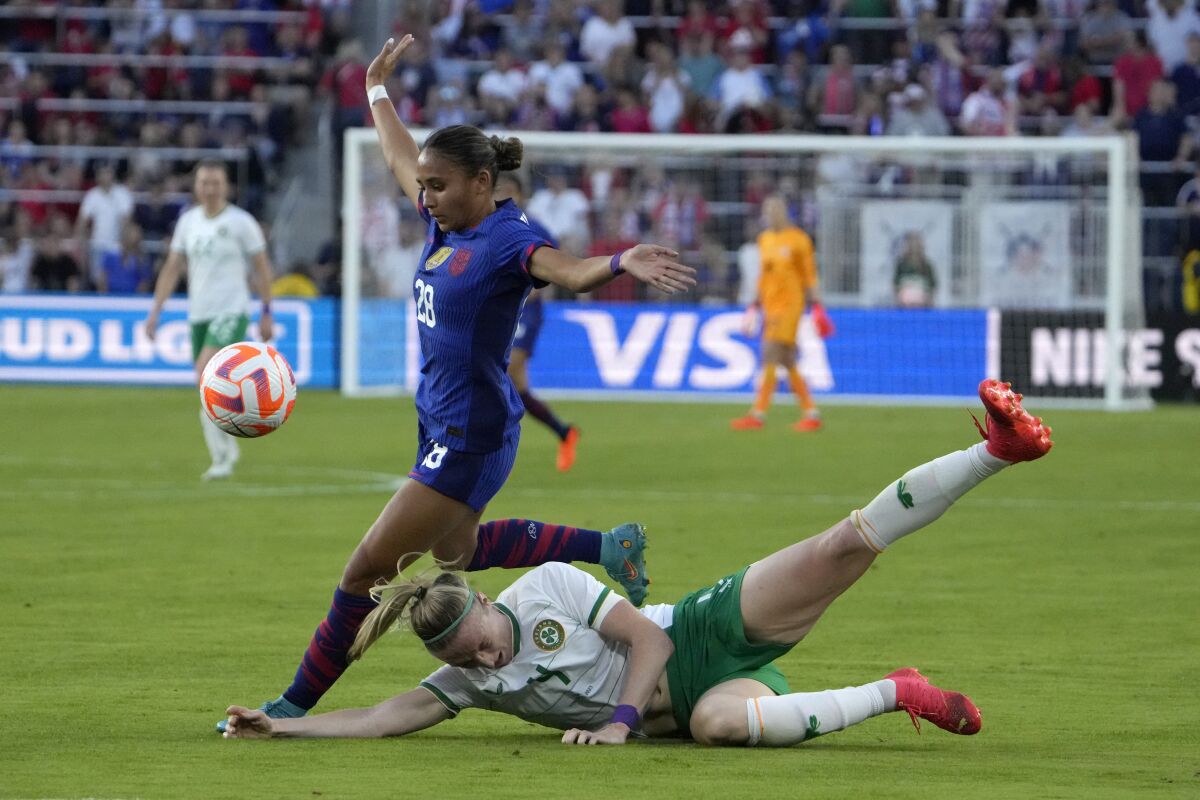 U.S. forward Alyssa Thompson, left, and Ireland's Louise Quinn battle for the ball.