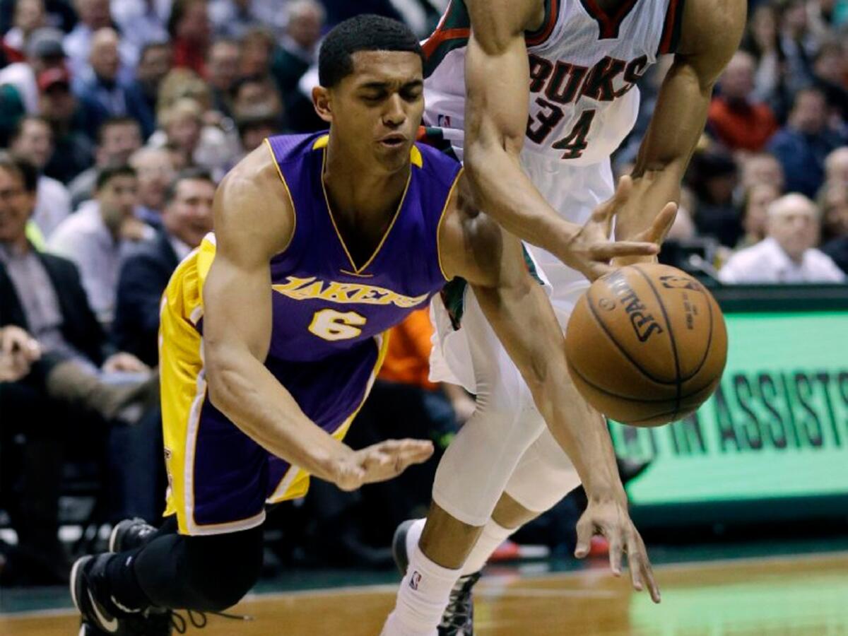 Jordan Clarkson hits the deck as he and Bucks forward Giannis Antetokounmpo chase a loose ball during a game in Milwaukee on Feb. 4 last season.