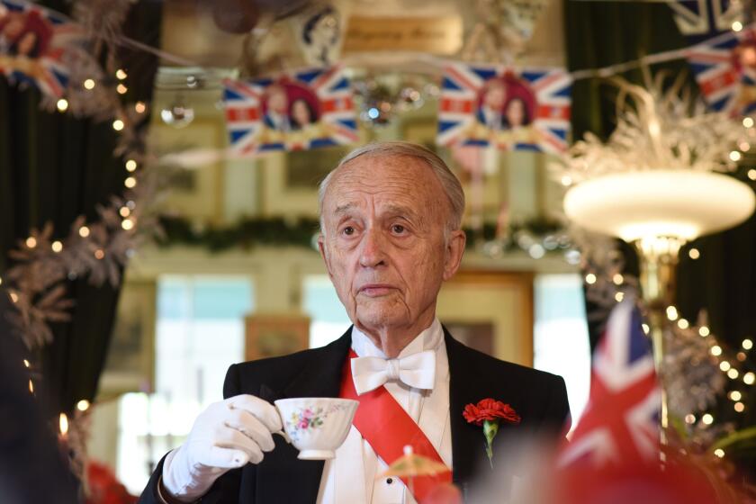 Owner Edmund Fry displays the proper way to hold a tea cup during an interview with AFP at The Rose Tree Cottage which serves traditional English afternoon tea, in Pasadena, north of Los Angeles, California, May 15, 2018, where Meghan Markle has been a guest, owner Fry offering her tips on how to correctly partake in afternoon tea. - The Rose Tree Cottage will celebrate the wedding of Prince Harry and Meghan Markle with a high tea on Saturday, May 19, 2018 with replays of the royal wedding on the television. Guests are suggested to dress up in the spirit of the wedding, in "bridesmaid dresses, veils or whatever they have in their cupboard." (Photo by Robyn Beck / AFP) (Photo credit should read ROBYN BECK/AFP via Getty Images)