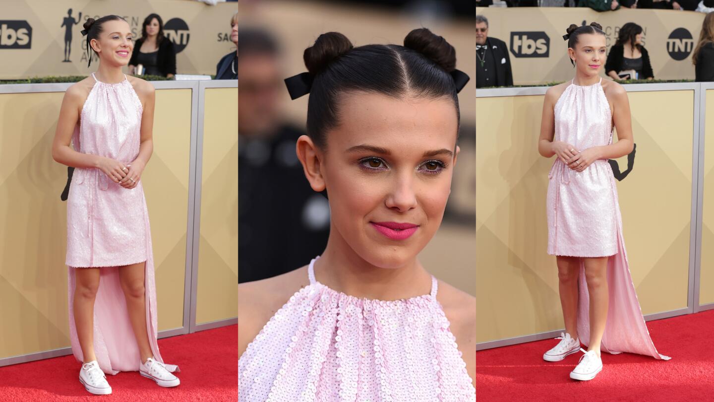 The high-low hem of Millie Bobby Brown's Calvin Klein dress gives it a cape-like feel making the "Stranger Things" star one of the evening's sartorial superheroes.