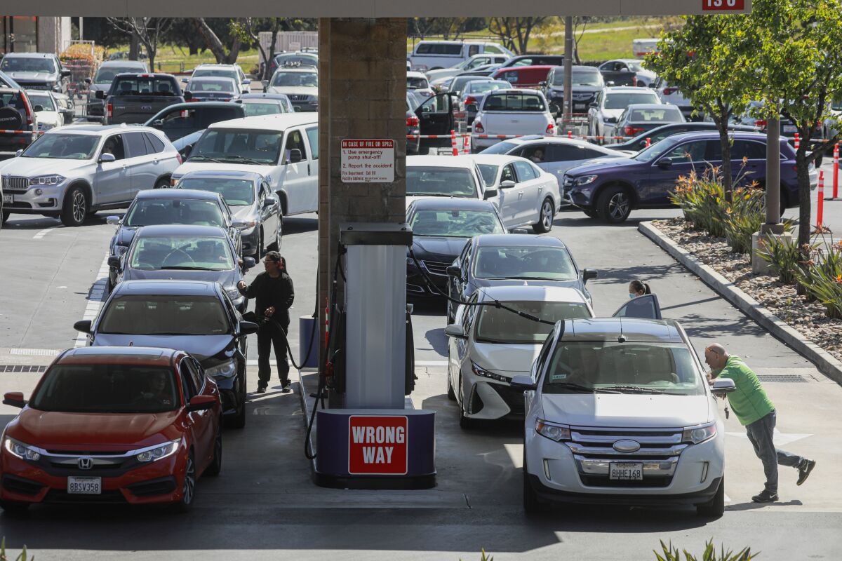 Motorists wait in line to fill up at a Costco.