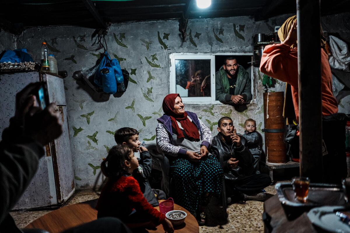 Adults and children in a lighted room.