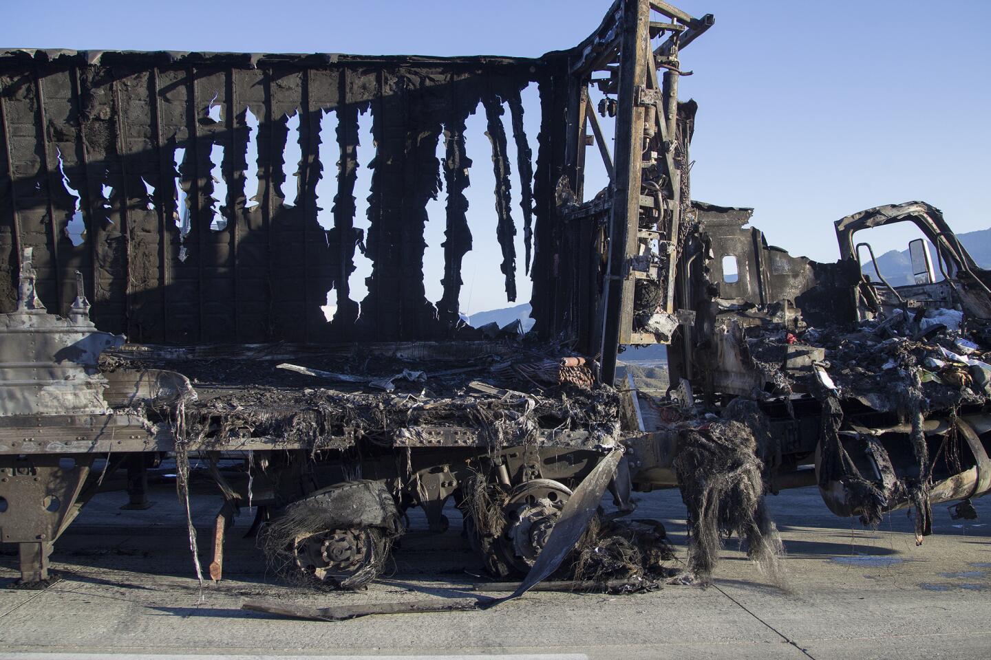 The melted shell of a big rig after a fast-moving brush fire forced drivers and passengers to abandon their vehicles July 17, 2015, in Southern California's Cajon Pass.