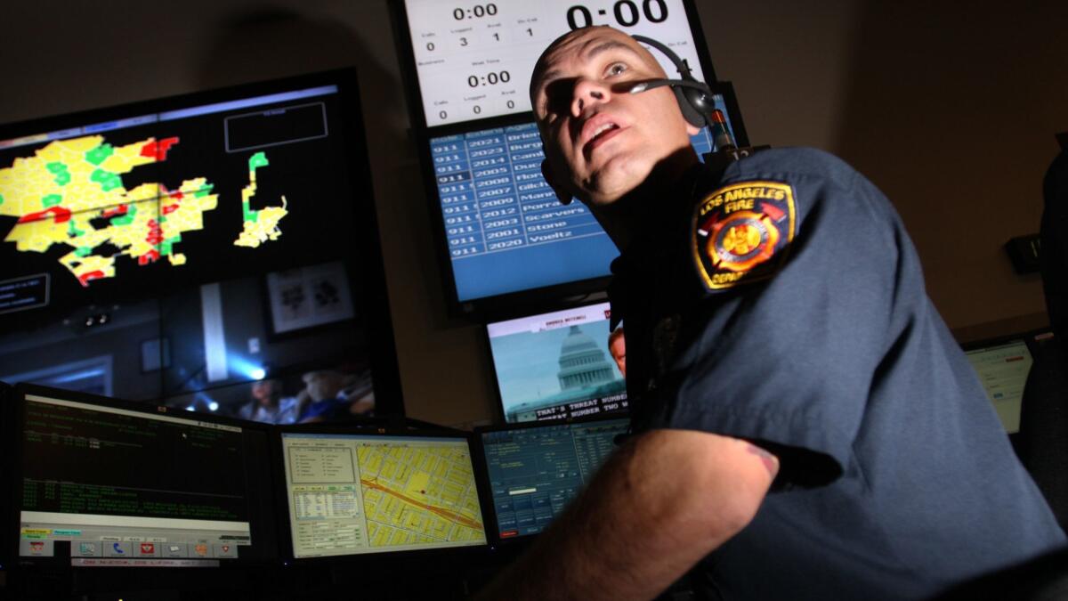 Dispatcher Tony Porrata takes a call at the Los Angeles Fire Department Dispatch Center in 2012.