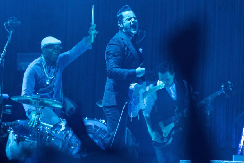 Jack White, center, and his band perform Saturday night at the Coachella Valley Music and Arts Festival in Indio.