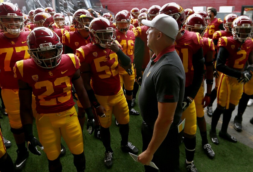USC coach Clay Helton leads the Trojans unto the field before a game against Oregon on Nov. 2 at the Coliseum.