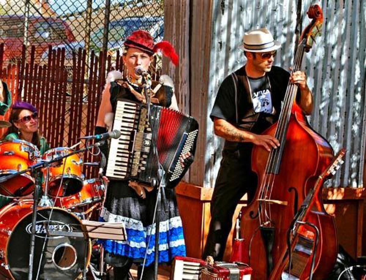 Las Goats plays outside the Bisbee Grand Hotel. The old mining town has a lively and eclectic music scene populated with gypsies, vagabond musicians and other free spirits. FOR THE RECORD: Band name: An earlier version of this caption identified the band above as the Dusty Buskers. The band playing is Las Goats.