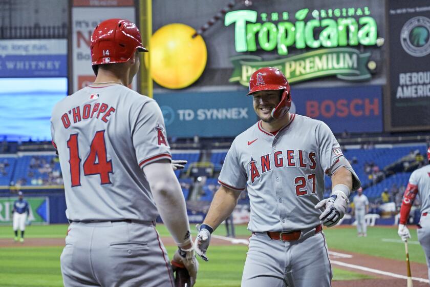 Los Angeles Angels' Logan O'Hoppe (14) greets Mike Trout (27) after Trout's solo home run off Tampa Bay Rays starter Zack Littell during the first inning of a baseball game Wednesday, April 17, 2024, in St. Petersburg, Fla. (AP Photo/Steve Nesius)