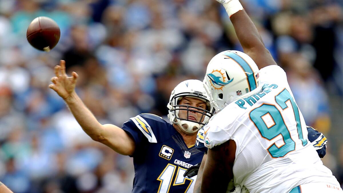 Chargers quarterback Philip Rivers attempts a pass against the Dolphins in the second quarter Sunday.