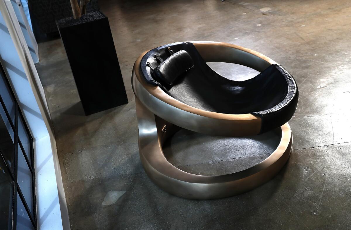 A bronze and Italian leather Phantom-inspired sculptural lounge chair inside the new Hoorsenbuhs store.