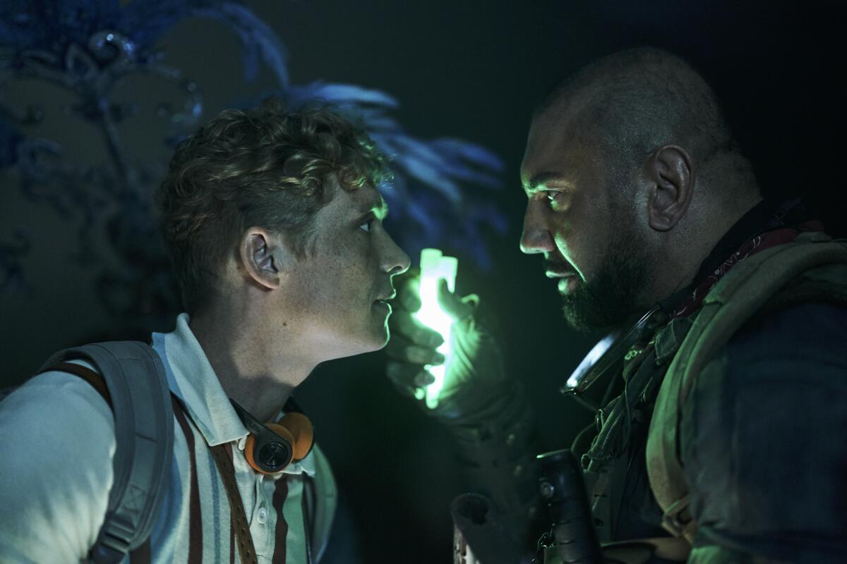 This image released by Netflix shows Matthias Schweighofer, left, and Dave Bautista in a scene from "Army of the Dead." (Clay Enos/Netflix via AP)
