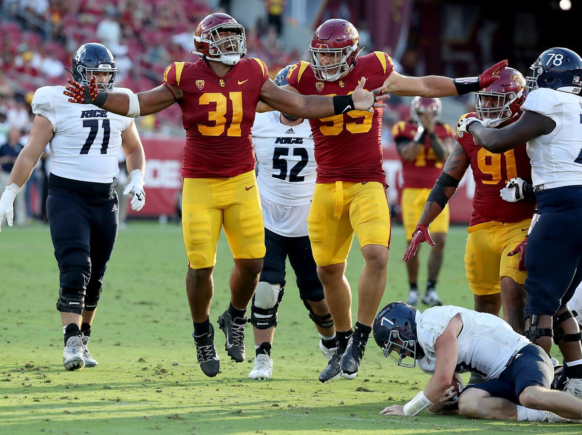USC defensive tackle Tyrone Taleni (31) celebrates after sacking Rice quarterback TJ McMahon on  Saturday.