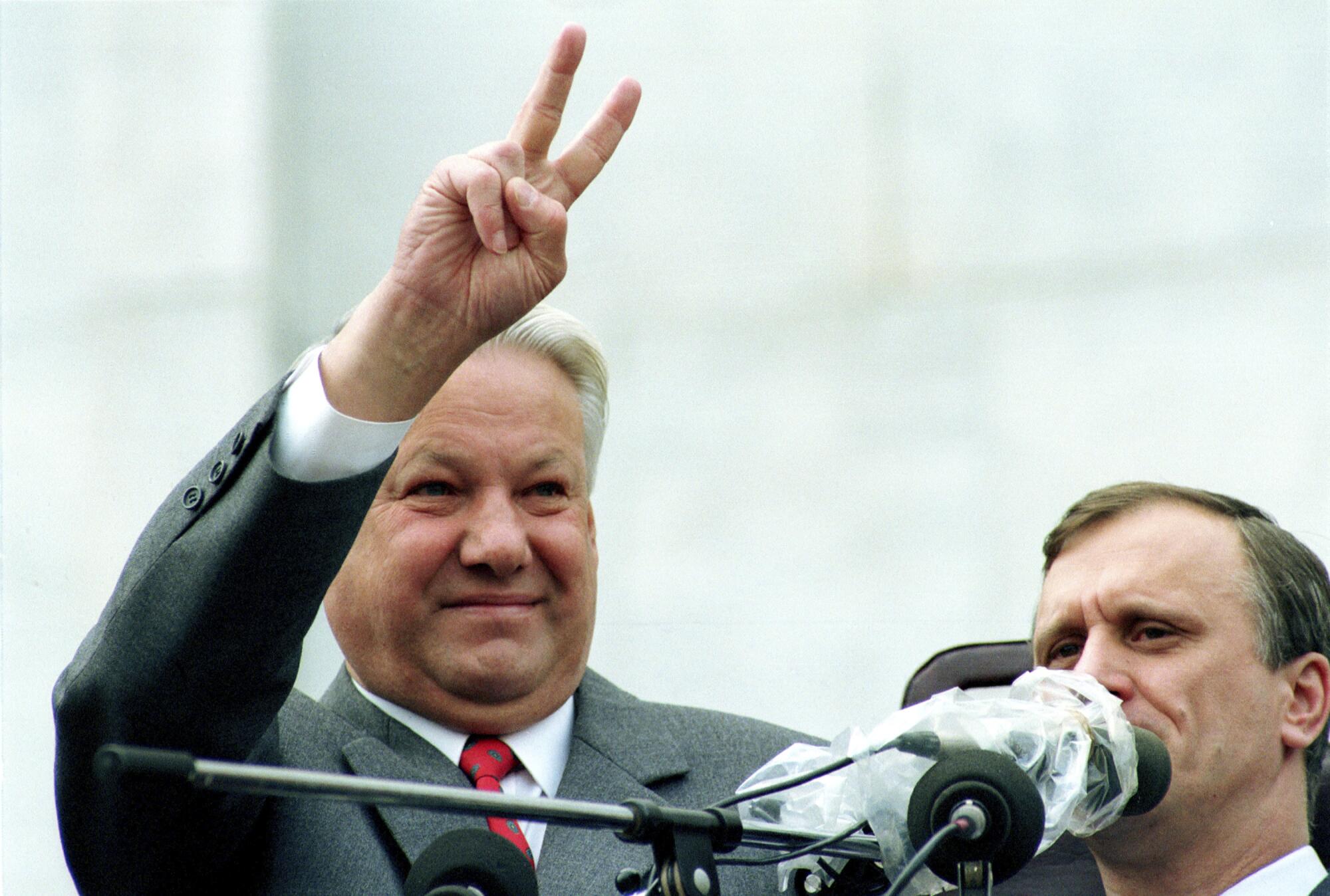 Boris Yeltsin makes a V-sign at a rally