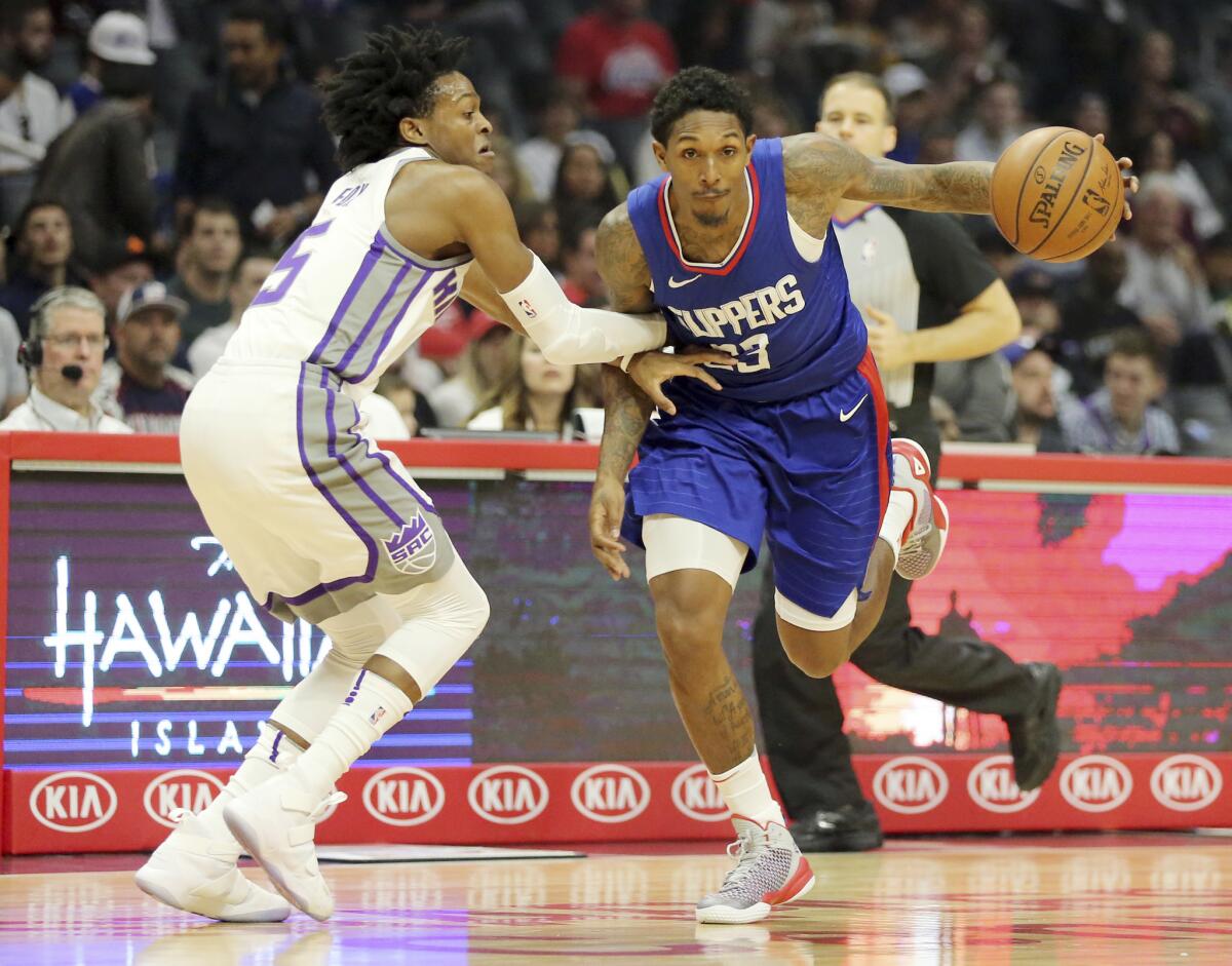 Point guard De'Aaron Fox, defending Clippers guard Lou Williams, has been a solid fit with Buddy Hield for the Kings backcourt.