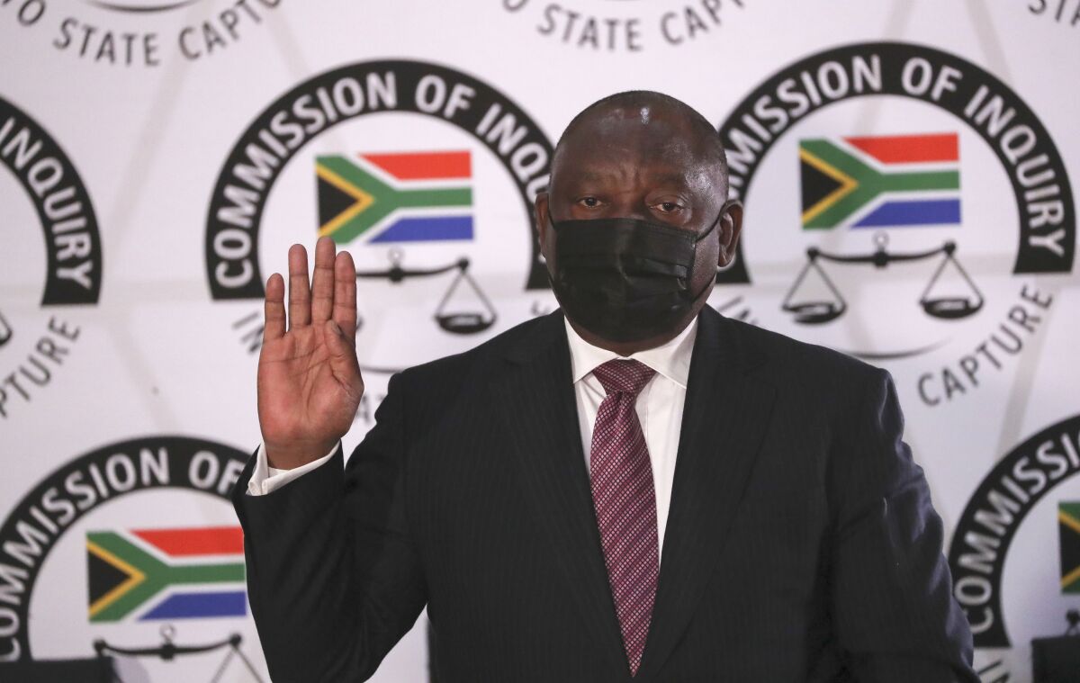 South African President Cyril Ramaphosa takes the oath as he appears at the Zondo Commission of Inquiry into State Capture and Corruption in Johannesburg Wednesday, Aug. 11, 2021. Ramaphosa is appearing in his capacity as the President and former Deputy President of the Republic of South Africa. (AP Photo/Sumaya Hisham/Pool)